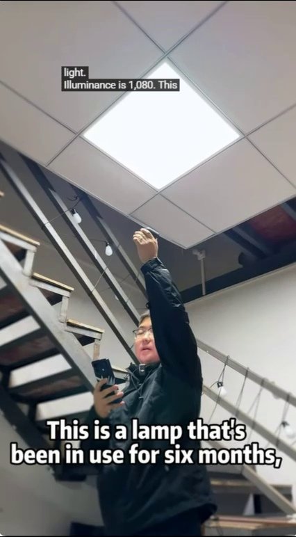 Lux meter positioned below an LED ceiling light during the brightness comparison test